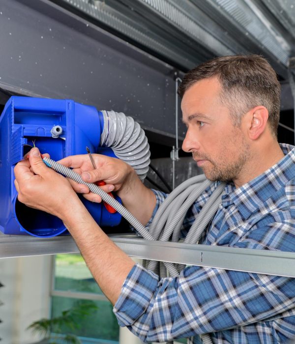 Man repairing ventilation system